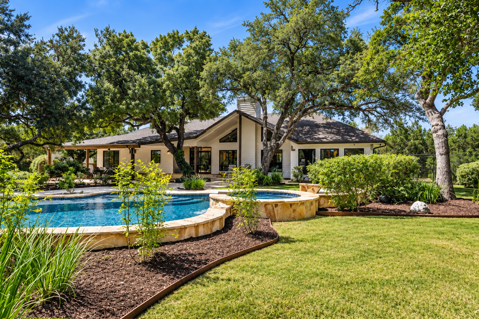Bulverde TX real estate featuring an acreage home with a pool and mature oak trees