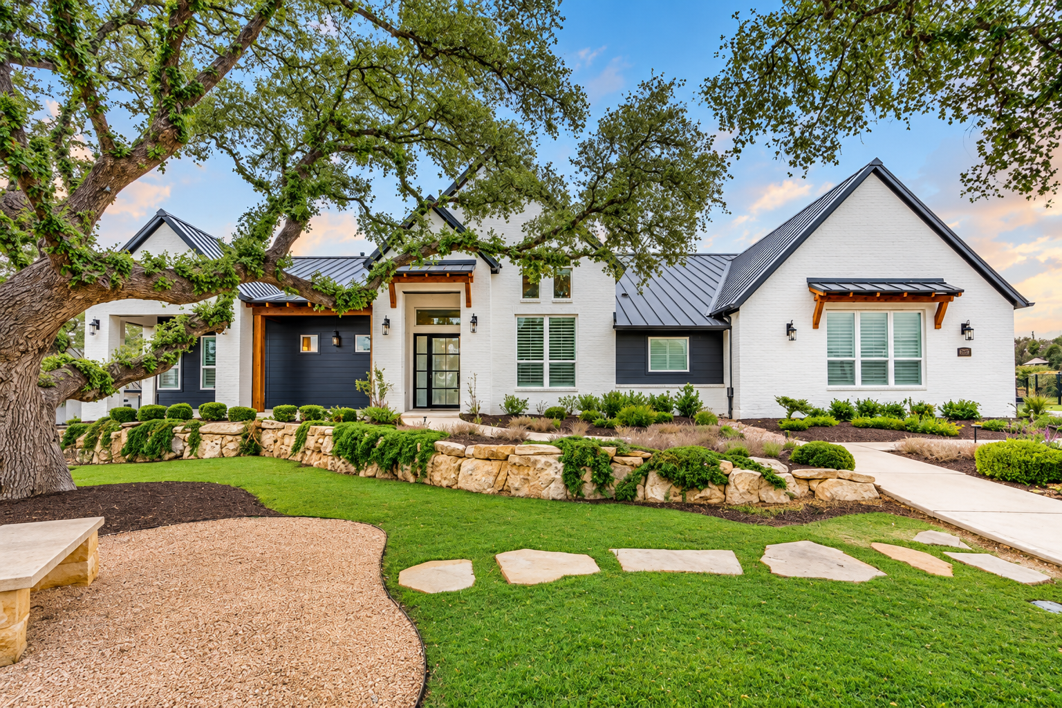 Modern white Rialto custom home with metal roof and landscaped front yard in Cantera Hills 